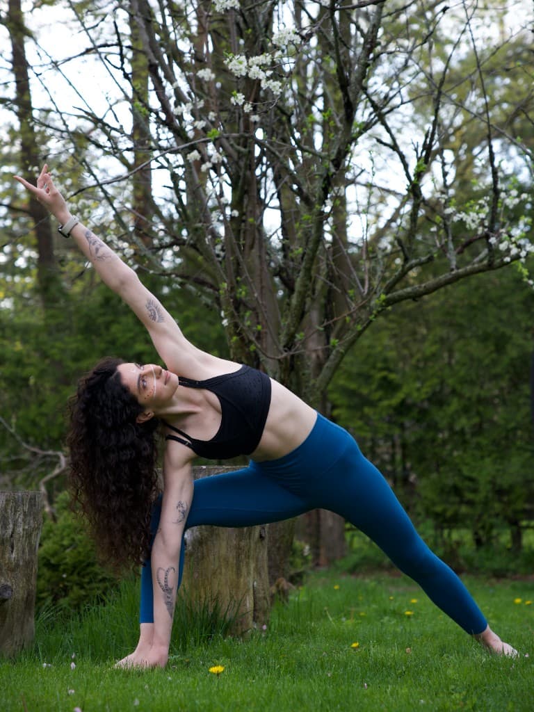 Linda in extended side angle pose outdoors on the mat